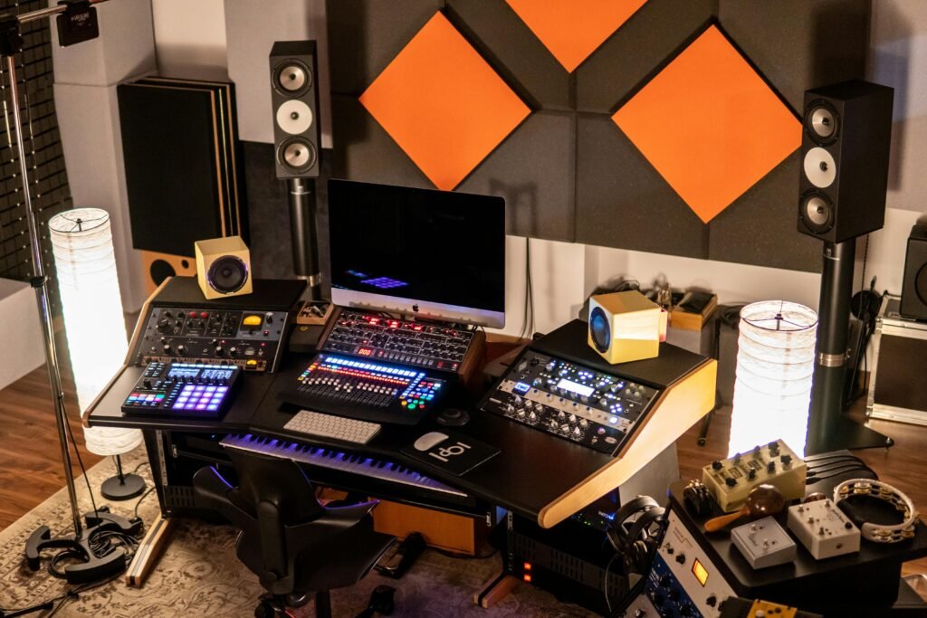 A well-equipped music studio with audio mixers and monitors in a creative setup.